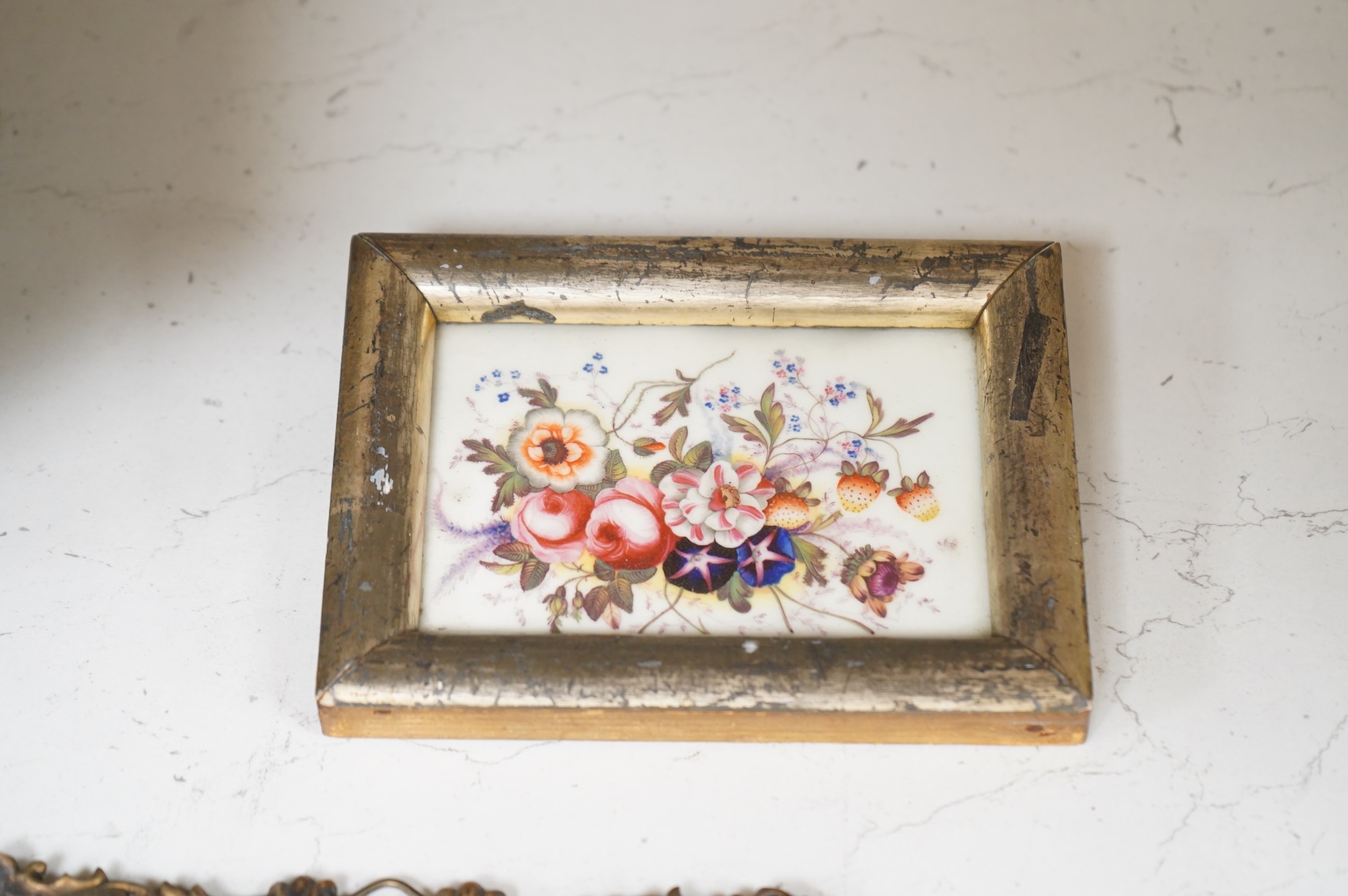 A collection of 19th century porcelain panels, pot lids and plaques to include a pair of hand painted floral lids, Russian lacquered box depicting a lady and a late 19th century Continental brass framed convex oval ename